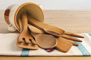 posate di legno dentro vaso di coccio rovesciato e tovagliolo altra vista