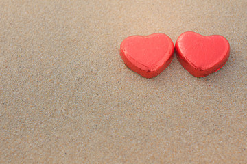 Fototapeta premium Chocolate color Lovely red heart on the beach. Background is a natural in real place, creative Valentine's Day Concept, tropical style background made in Phuket, Thailand.