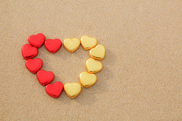 Chocolate color Lovely red golden heart on the beach. Background is a natural in real place, creative Valentine's Day Concept, tropical style background made in Phuket, Thailand.