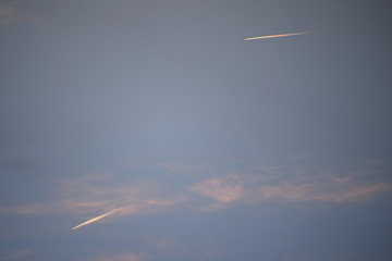 wake of aircraft among storm clouds in the light of dawn on a dawn of early spring days. Vitoria-Gasteiz (Alava) Basque Country, Spain