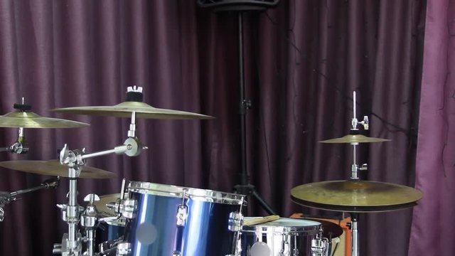 A young guy gets up and leaves because of the drum kit.