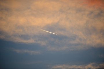 wake of aircraft among storm clouds in the light of dawn on a dawn of early spring days. Vitoria-Gasteiz (Alava) Basque Country, Spain