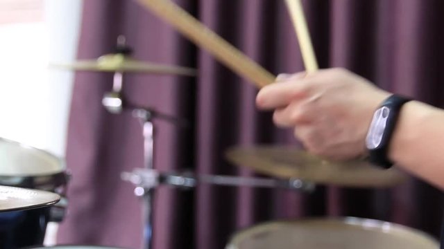 Drummer giving score with drumsticks
