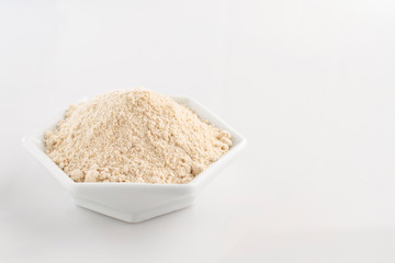banana flour in bowl isolated on white background