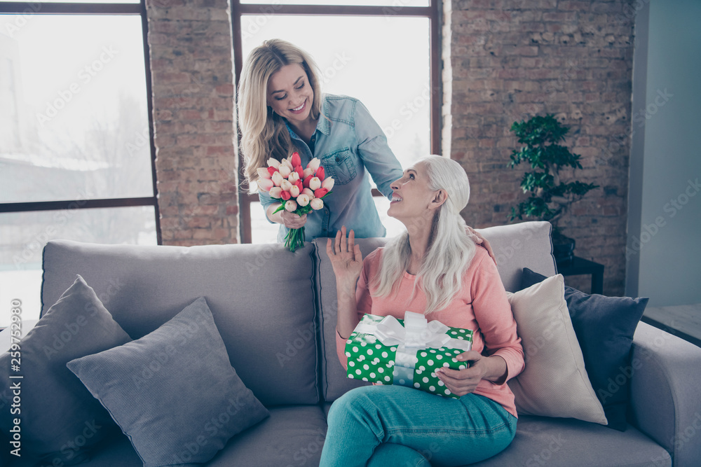 Sticker Close up photo two people she her ladies child grandmother grandchildren visit birthday party deliver mommy giftbox fresh flowers casual domestic clothes sit comfy couch divan flat house indoors