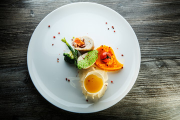top view dissected stuffed chicken with pumpkin puree and yellow sauce