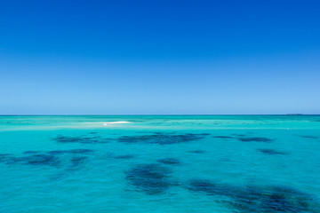 Obraz premium beautiful great barrier reef with white clouds on a sunny day, cairns, australia