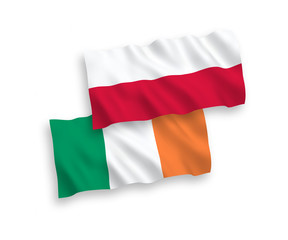 National vector fabric wave flags of Ireland and Poland isolated on white background. 1 to 2 proportion.