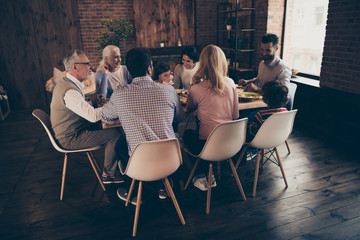 Close up back rear behind photo big family relatives bonding company members brother sister granny mom dad grandpa little son daughter sit festive holiday dishes table loft house indoors