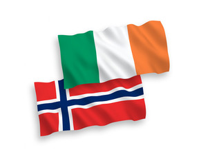National vector fabric wave flags of Norway and Ireland isolated on white background. 1 to 2 proportion.