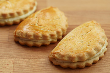 Freshly baked sochni. Wooden background, high resolution
