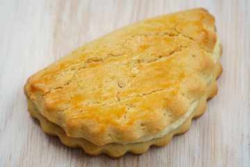 Freshly baked sochni. Wooden background, high resolution