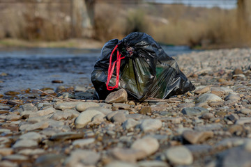River pollution near the shore, garbage pack near the river, plastic food waste, contributing to pollution