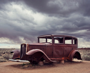 Fototapeta premium Route 66 vintage car relic near the north entrance of Petrified Forest National Park in Arizona, USA