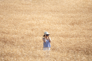 beautiful woman who enjoys shooting in barley fields.