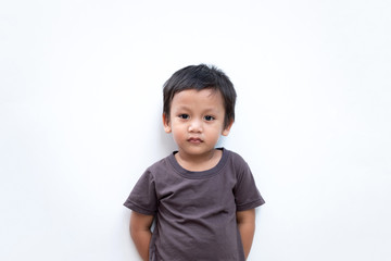 Portrait of a toddler boy wearing grey T-shirt on white background