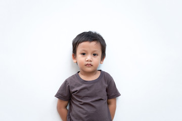 Portrait of a toddler boy wearing grey T-shirt on white background