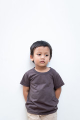 Portrait of a toddler boy wearing grey T-shirt on white background