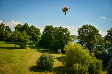 Bride throwing a bouquet of flowers in the air