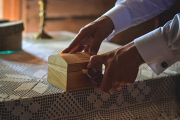 Person closing a lock on a small wood box