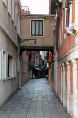 Fototapeta na wymiar Narrow old street in Venice Italy