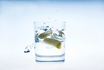 Lemon splashes in a water glass
