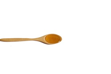 One teaspoon of organic honey in white isolated background 