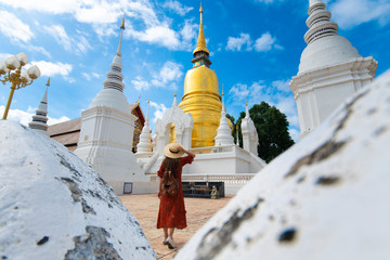 Tourist woman is sightseeing in Wat Suan Dok in Chiangmai, Thailand during summer time.