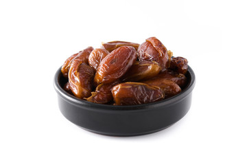 Dates in black bowl isolated on white background