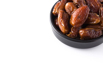 Dates in black bowl isolated on white background. Copyspace