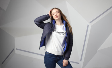 Young girl girl wearing  jacket with area for your logo, mock-up of white women hoodie, on modern wall 