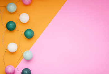 Colorful handmade ropes circle lamps on pink and orange background.Top view.Cope space.