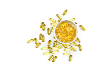 Top view of Gold fish oil isolated on white background. For good health. Capsules salmon fish oil. Omega 3. Vitamin E. Supplementary food.