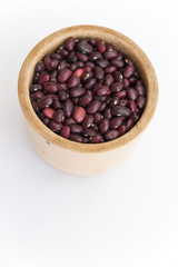 red beans in a wooden plate on a white background