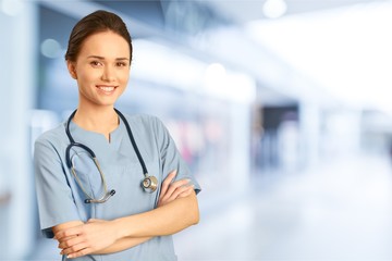 Male doctor with stethoscope on blurred hospital background