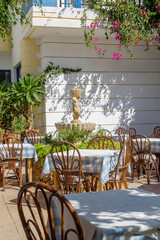 Wooden tables and chairs of a street restaurant
