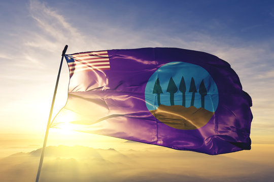 Bomi county of Liberia flag waving on the top sunrise mist fog