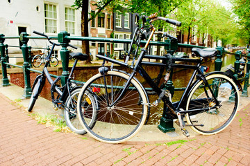 Fototapeta na wymiar Bicycles parked on street in Amsterdam, The Netherlands