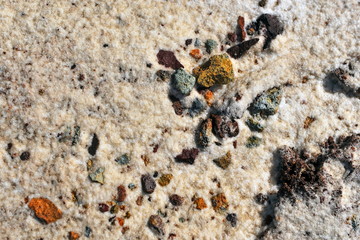 Multi-colored stones on the sand.