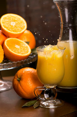 glass of fresh orange juice with fresh fruits on wooden