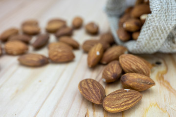almonds and nuts on wooden table