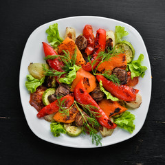 Salad with grilled vegetables. Top view. Free space for your text. Rustic style.