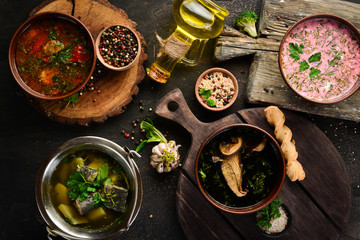 Ukrainian cuisine. Borsch soup with mushrooms, fish soup. Top view. Free space for your text. Rustic style.