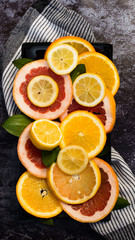 Colorful assortment of  citrus fruits. Dark background