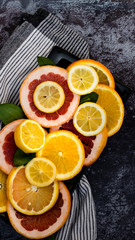 Colorful assortment of  citrus fruits. Dark background