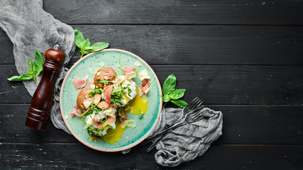 Sandwich with proshutto, egg and arugula. Breakfast. In the plate. Top view. Flat lay composition Free copy space.