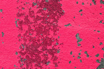 Texture of bright red or pink peeling paint background on concrete wall
