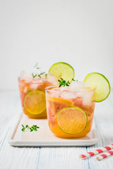 Grapefruit lime iced cocktail on light blue background. Selective focus, space for text.