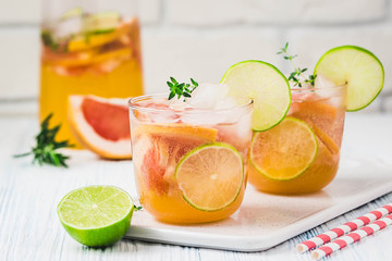 Grapefruit lime iced cocktail on light blue background. Selective focus, space for text.