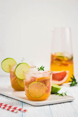Grapefruit lime iced cocktail on light blue background. Selective focus, space for text.